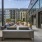 Courtyard with seating, greenspace and pool with lounge seating