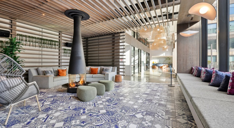 Well-lit common space area with plush seating and firepit